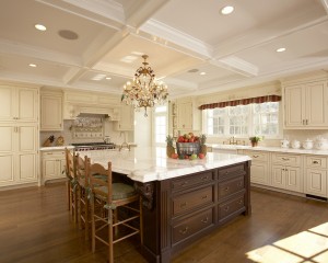 Custom kitchen cabintry in glazed white with contrasting large, Carrera marble topped island in chocolate wood.